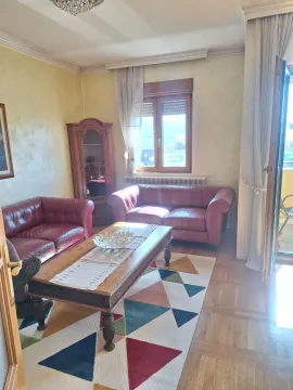 Living room with a sofa set and a wooden coffee table. - image 2