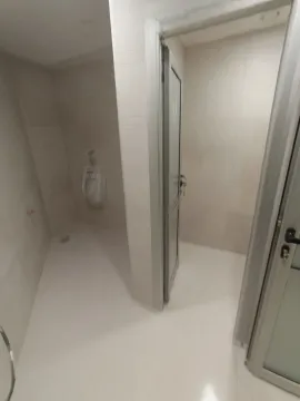A simple tiled restroom with a urinal and partitions. - image 12