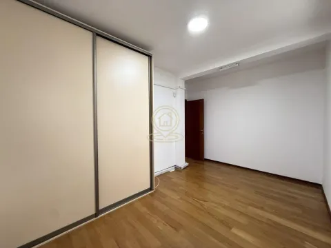 Empty room with a built-in wardrobe and wooden flooring. - image 4