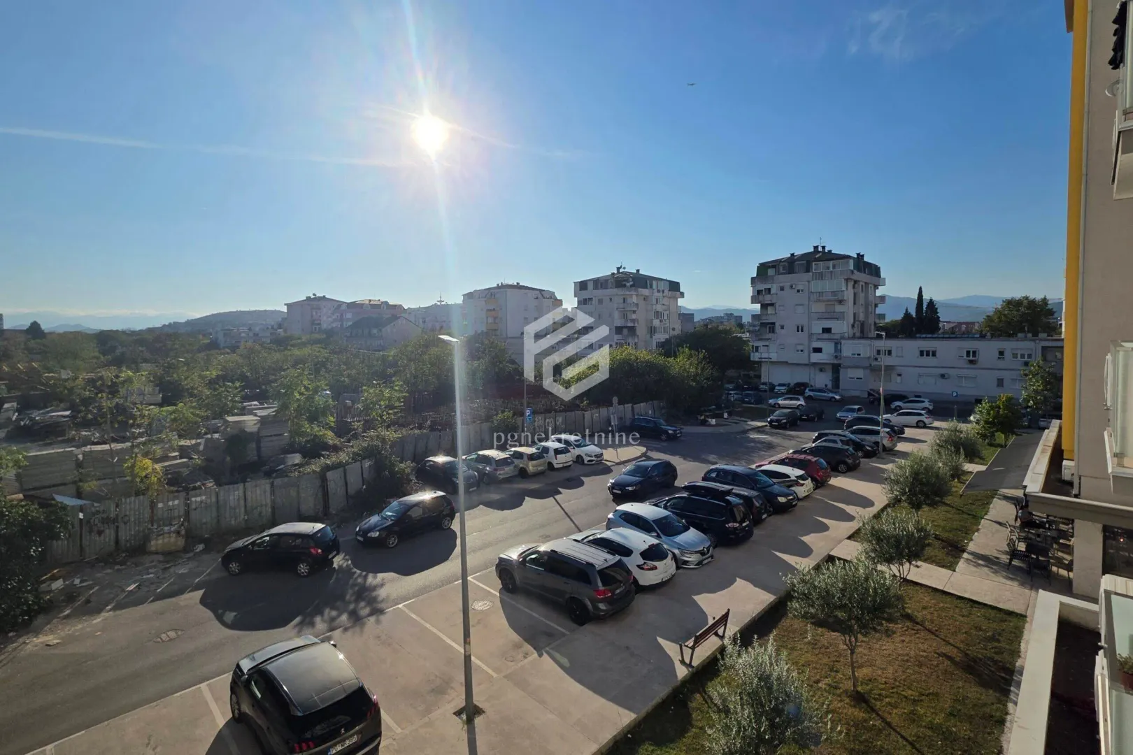 View from the terrace overlooking the parking lot and surrounding buildings.