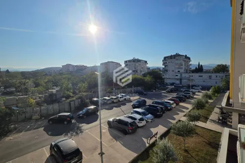 View from the terrace overlooking the parking lot and surrounding buildings. - image 13