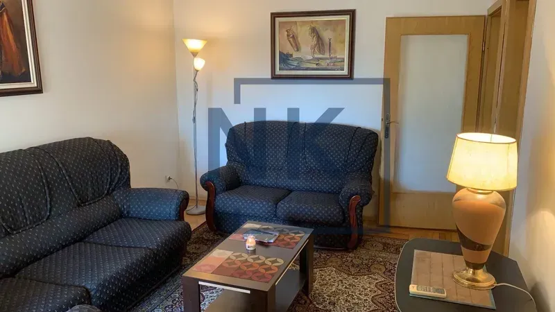Living room with a sofa set, coffee table, and a lamp.
