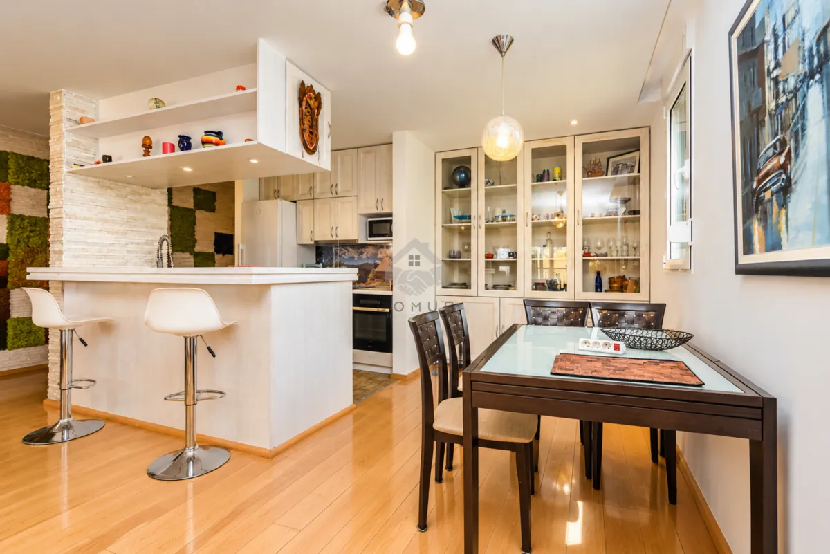 Kitchen with a breakfast bar and dining table.