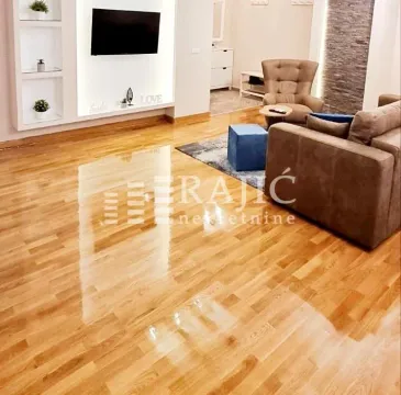 Living room with a sofa set and parquet flooring. - image 18