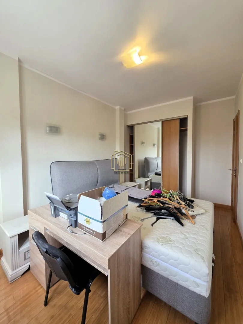 Bedroom with a double bed, desk, and wardrobe.