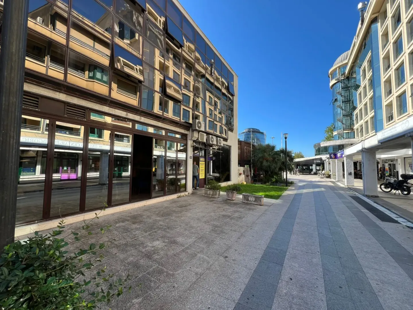 View of the exterior of the building and the pedestrian walkway in front of the premises.