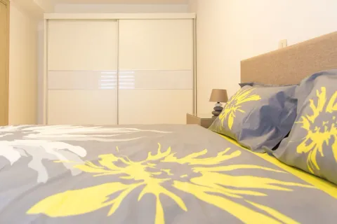 Bedroom with a double bed, bedside table, and fitted wardrobe. - image 5