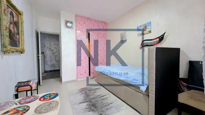 Smaller bedroom with a bed and a fitted wardrobe.