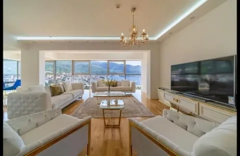Spacious living room with a sofa set, large TV, and sea view. - image 6