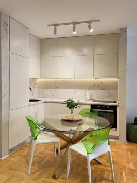 Modern kitchen with a dining table and chairs. - image 5