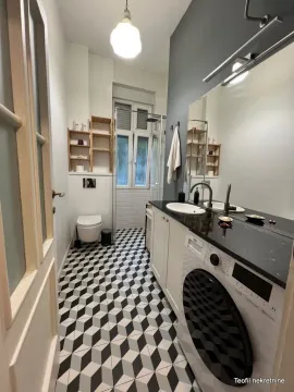 Modernly equipped bathroom with a washing machine and a shower cabin. - image 11
