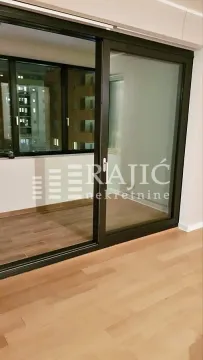 Empty room with hardwood floors and access to the terrace. - image 13