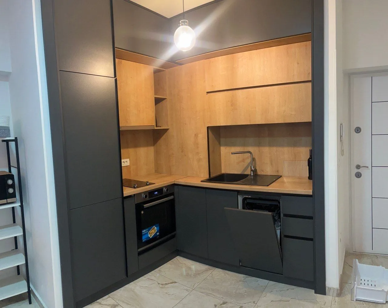 Modern dark-toned kitchen with wooden elements.
