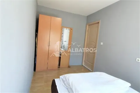 Small bedroom with a bed, wooden wardrobe, and a door. - image 4