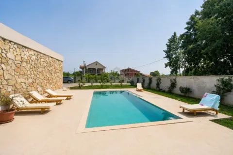 Swimming pool with a sunbathing area and sun loungers in the yard of the house. - image 38