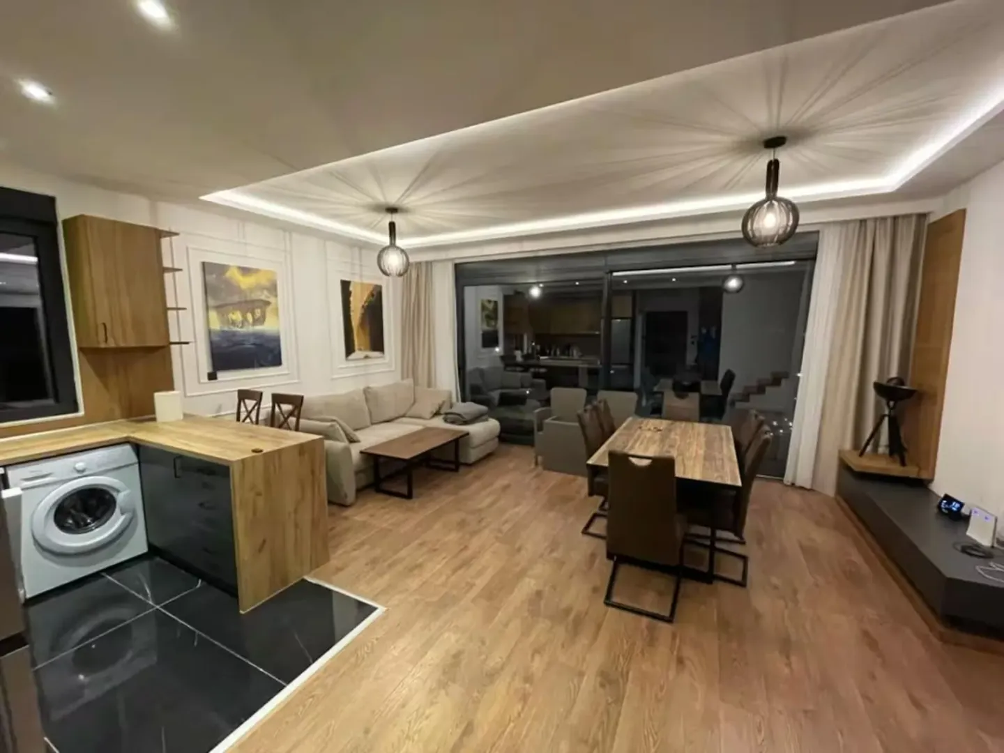 Open-plan living room with dining area and part of the kitchen.