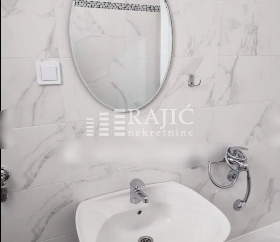 View of the washbasin with a mirror in the bathroom.