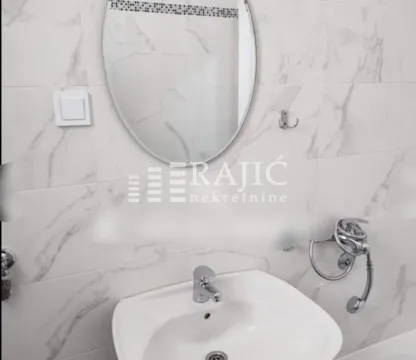 View of the washbasin with a mirror in the bathroom. - image 10