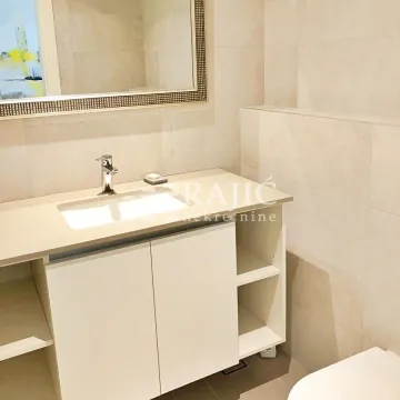 Modernly equipped bathroom with a vanity sink and a large mirror. - image 8