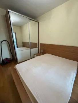 Bedroom with a double bed and a large fitted wardrobe with a mirror. - image 3