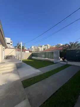 Yard of the house with a lawn and concrete pathway. - image 18