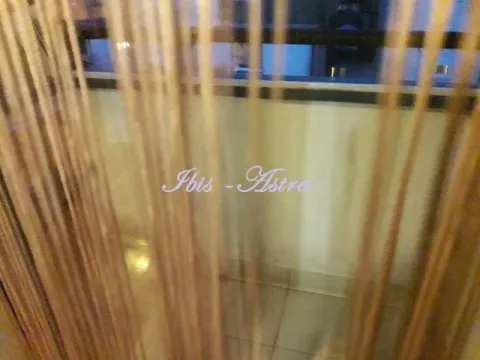 A view through decorative string curtains into the interior. - image 7