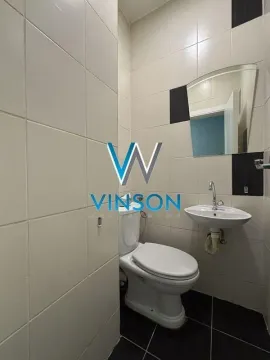 Small tiled bathroom with a toilet, washbasin, and mirror. - image 13