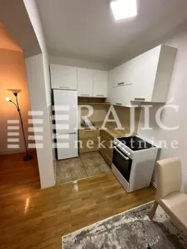 Small kitchen with white cabinetry and a dining chair. - image 6