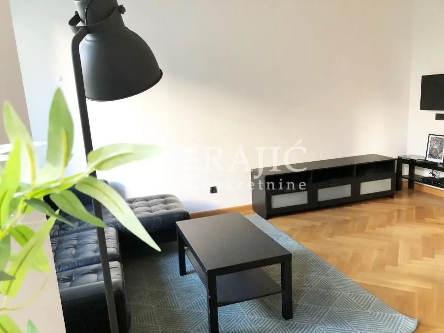 Living room with a sofa, coffee table, and TV unit.