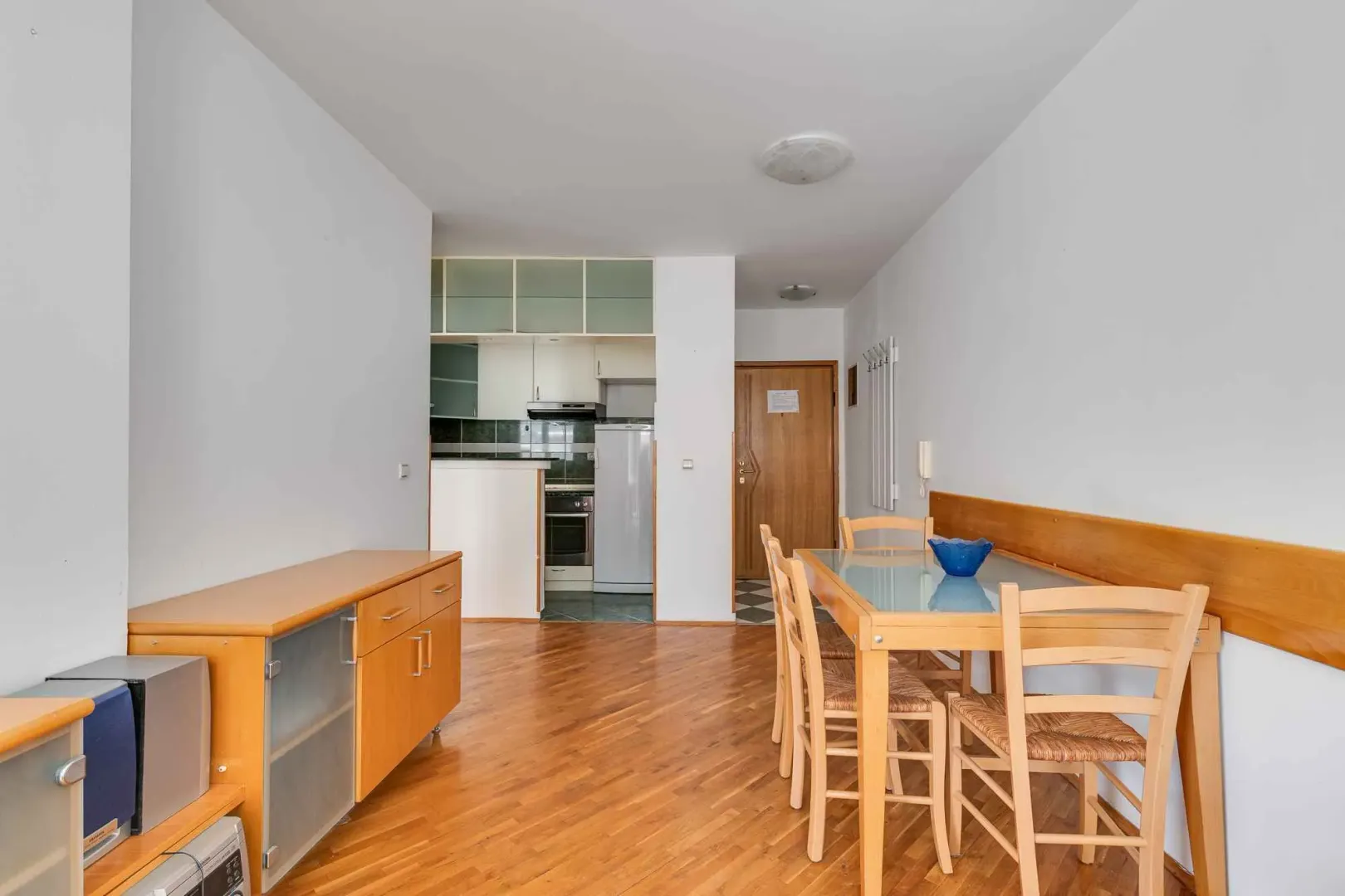 Living room with dining area and view of the kitchen.