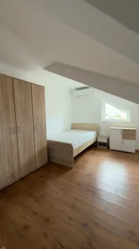 Furnished bedroom with a wardrobe and a bed under a sloping roof. - image 7
