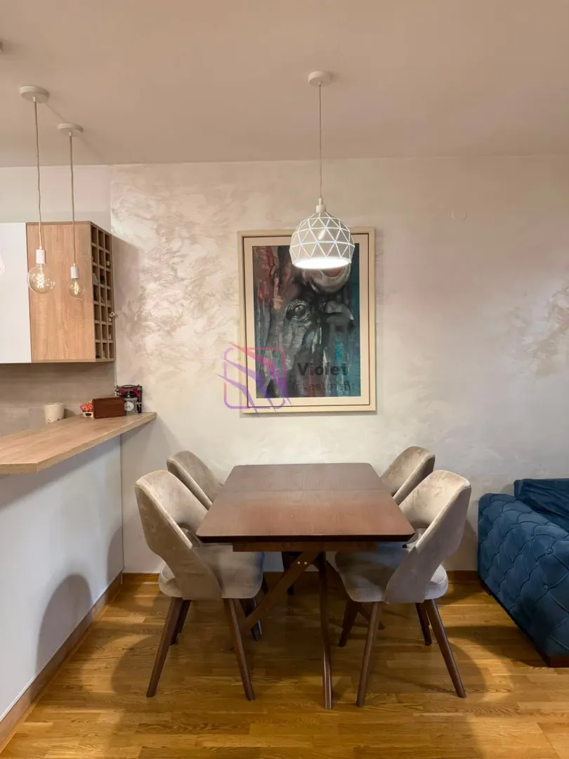 Dining area with a wooden table and upholstered chairs.