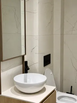 Modern bathroom equipped with a washbasin and marble-effect tiles. - image 11