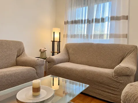 Living room with a sofa set, coffee table, and a floor lamp near the window. - image 2