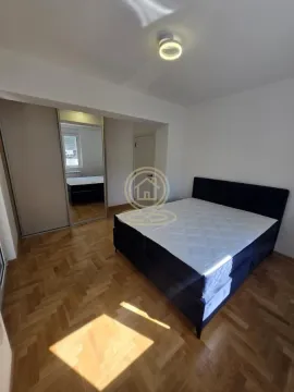 Bedroom with a double bed and a fitted wardrobe with a mirror. - image 3
