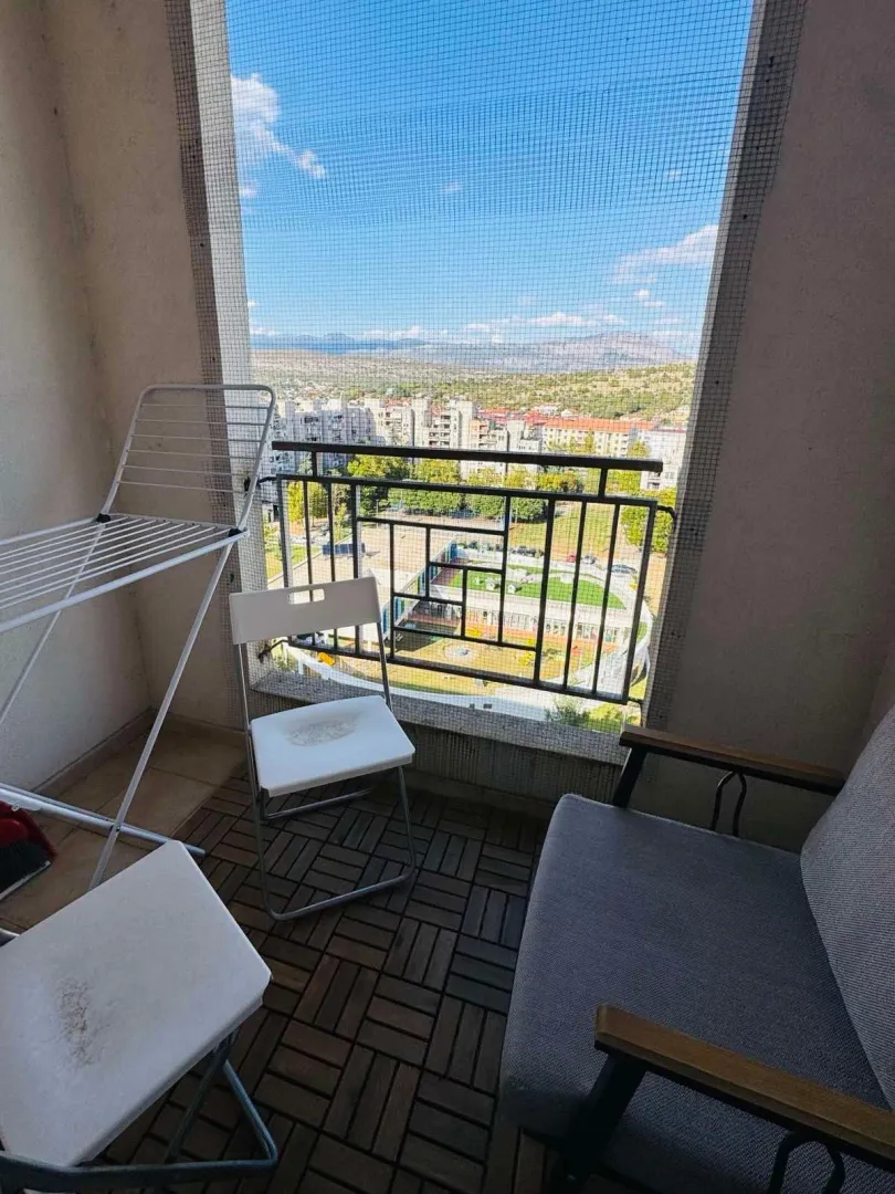 Small furnished balcony with a city view.