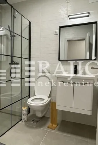 Modern bathroom equipped with a walk-in shower and vanity unit.
