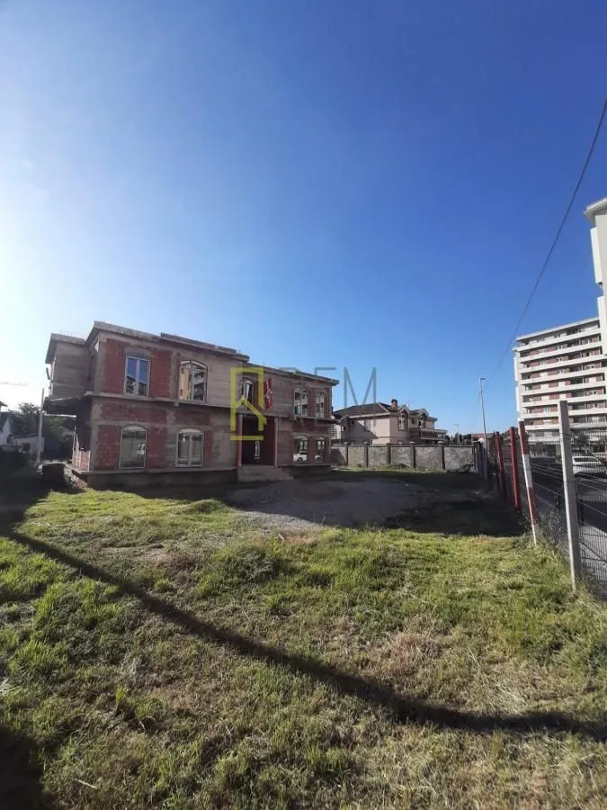 View of a house under construction with a yard.