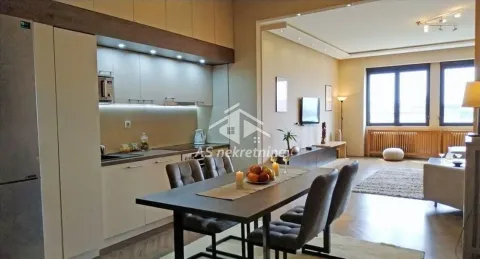 Open-plan space with a kitchen, dining area, and living room. - image 4