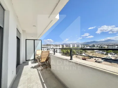 Spacious covered balcony with a view of the city and surrounding mountains. - image 12