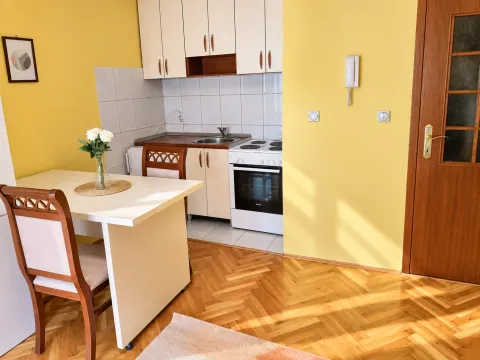 Small kitchen with a dining table and parquet flooring. - image 4