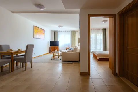 Spacious living room with a dining area and a view into the bedroom. - image 14