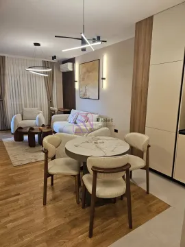 Modern living room with a sofa set, dining table and kitchen elements. - image 10