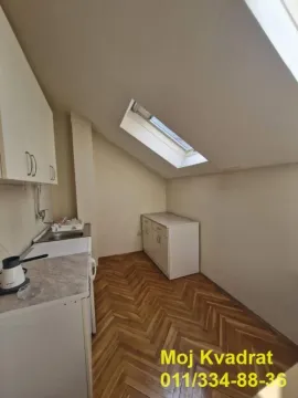 Small attic kitchen with a sink and a skylight. - image 6