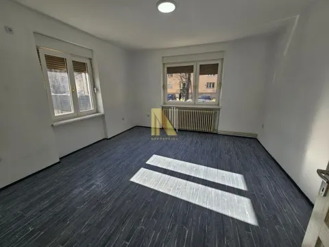 Empty room with white walls and dark flooring. - image 7