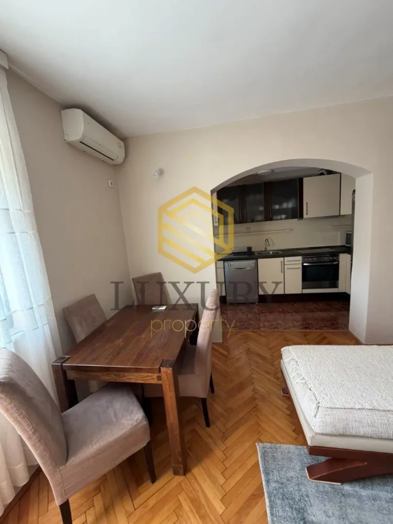 Living room with dining area and view of the kitchen.
