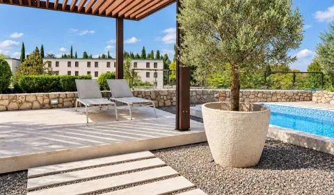 Terrace with a pergola, sun loungers, and a swimming pool. - image 24