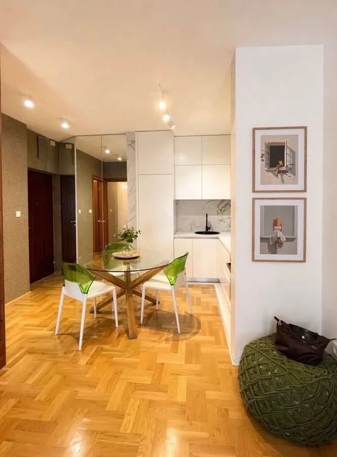 Living room with dining area and parquet flooring.