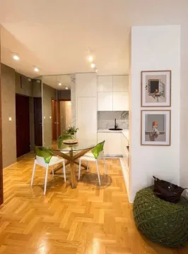 Living room with dining area and parquet flooring. - image 13