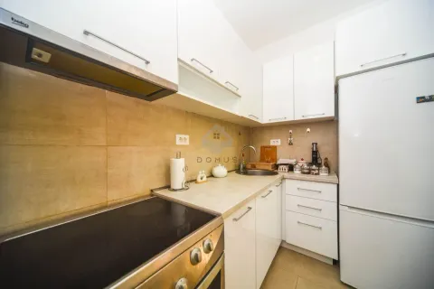 Compact white kitchen with built-in appliances and a stove. - image 5